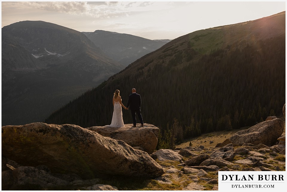 knoll willows open space elopement wedding standing on rock together watching the sun