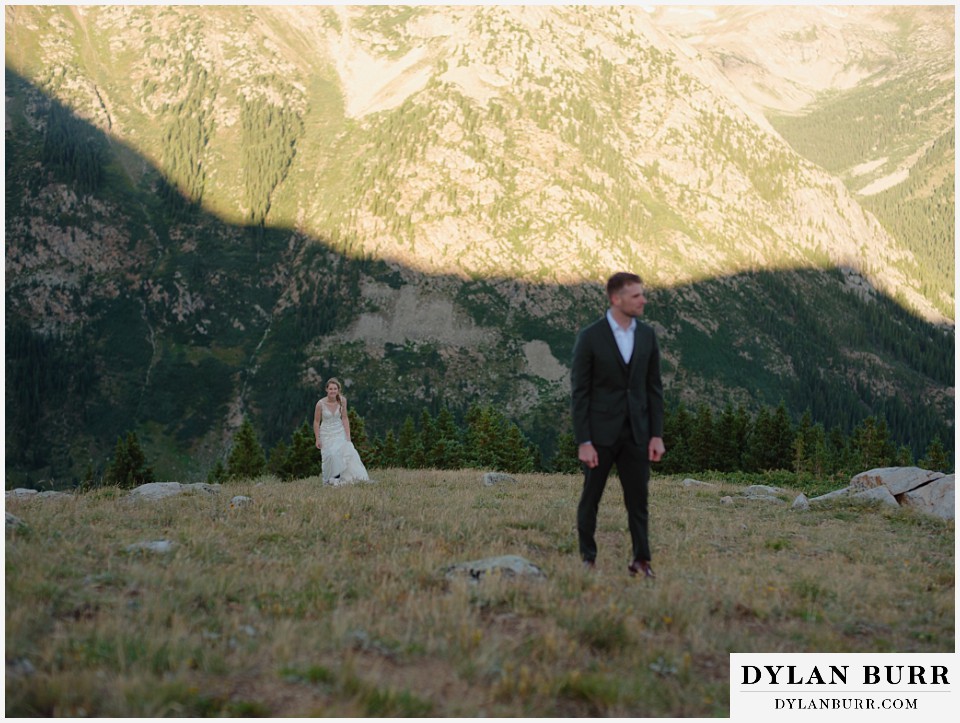 sunrise elopement wedding bride hiking up to groom for first look