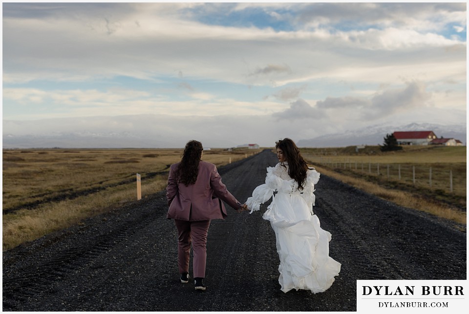 lgtbq iceland elopement wedding rural iceland brides walking on a lava rock road