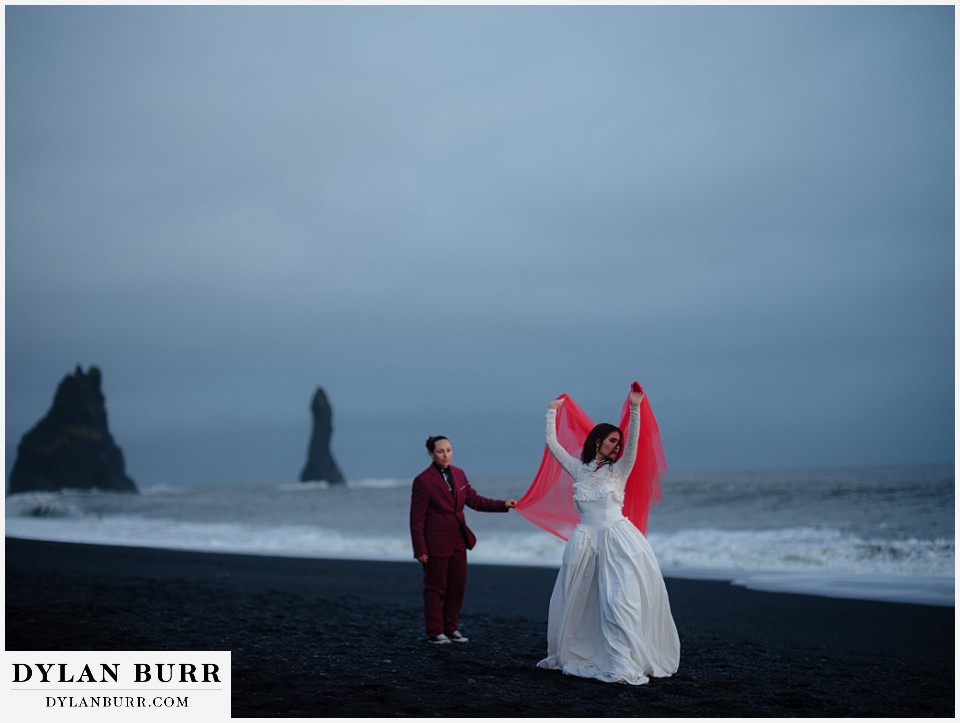 lgtbq iceland elopement wedding Reynisfjara beach dancing with red veil at beach