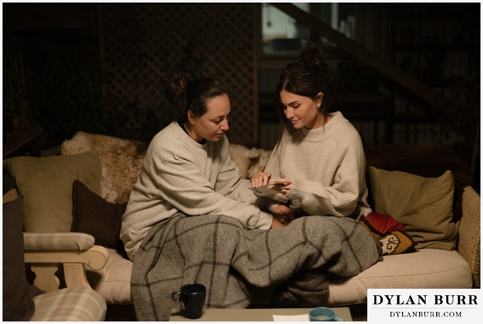 lgtbq iceland elopement wedding sitting together in cozy airbnb opening vows