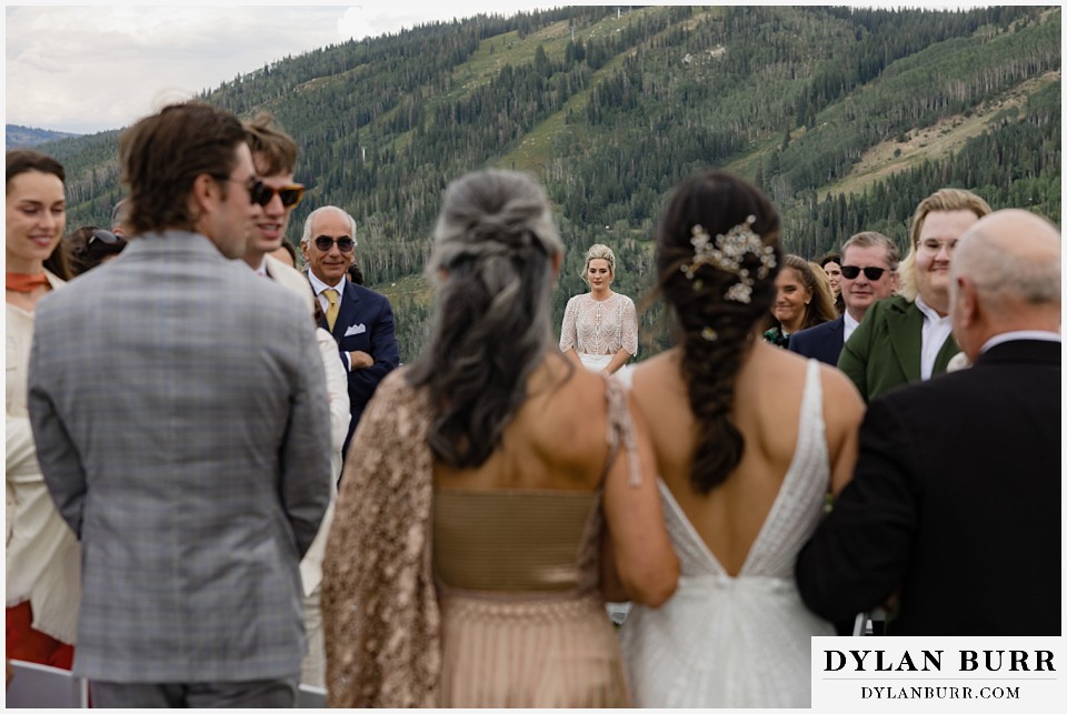 lgbtq wedding thunderhead lodge steamboat wedding brides walking down the aisle
