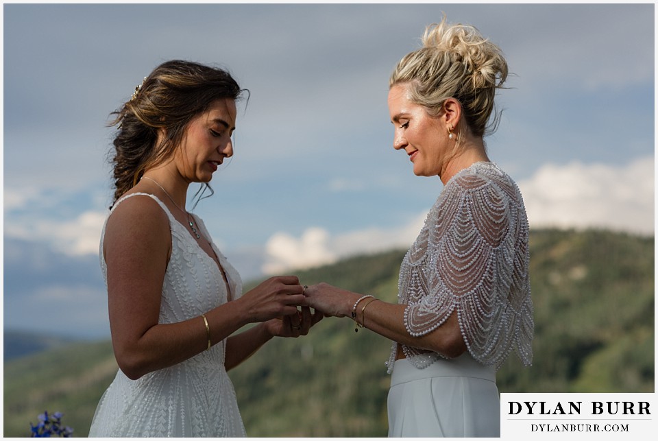 lgbtq wedding thunderhead lodge steamboat wedding exchanging rings