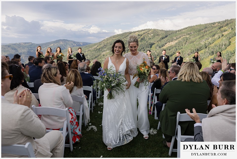 lgbtq wedding thunderhead lodge steamboat wedding brides walking down aisle together