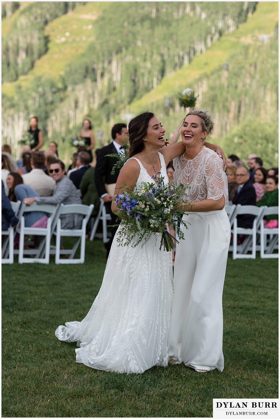 lgbtq wedding thunderhead lodge steamboat wedding newlywed brides laughing together after their ceremony