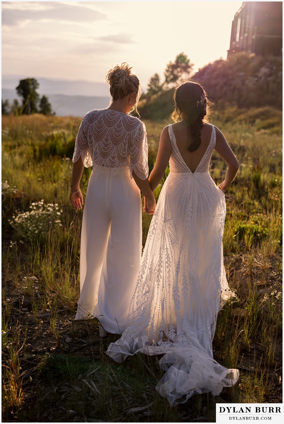 lgbtq wedding thunderhead lodge steamboat wedding brides walking together at sunset