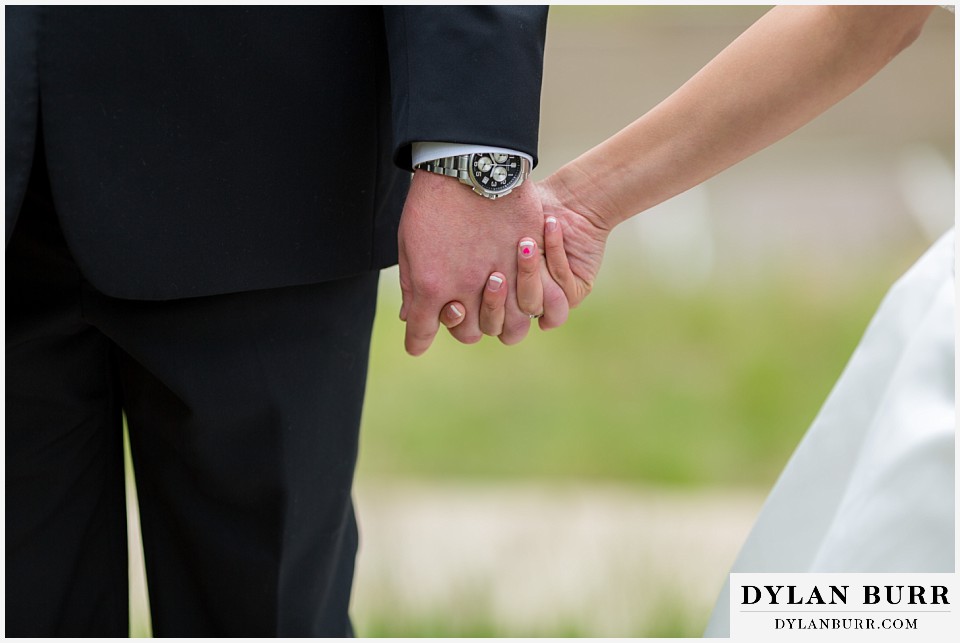 lookout mountain wedding bride and groom holding hands bride has a tiny pink heart on ring finger
