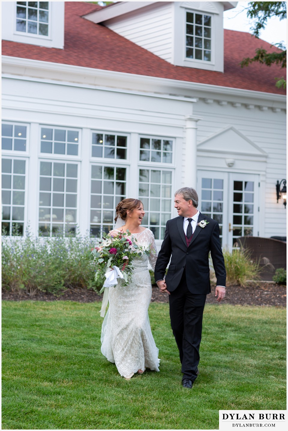 bride and groom walking outside the manor house in littleton colorado