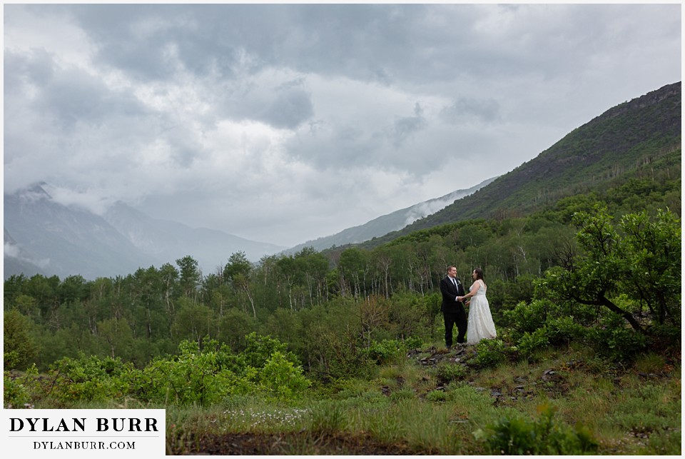 marble colorado elopement wedding couple standing on a hill in the rain