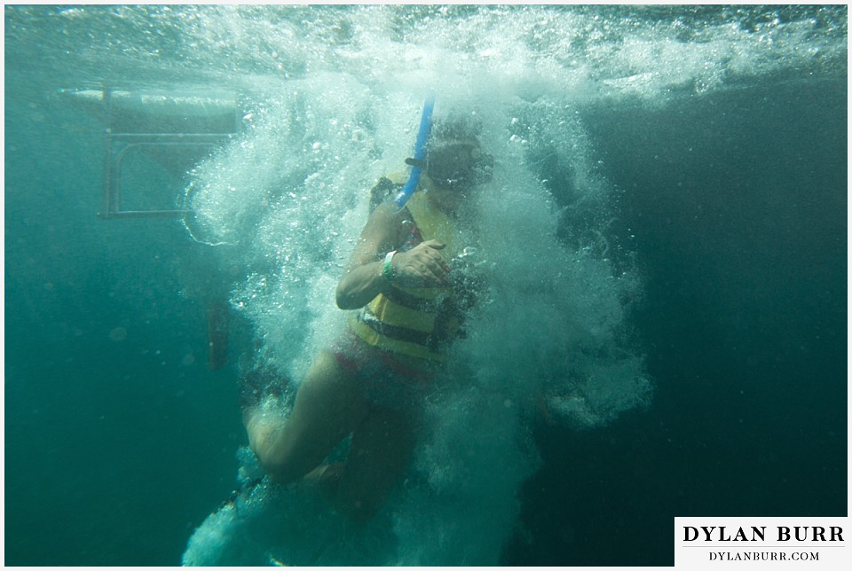 maroma adventures snorkling mexico destination wedding photographer bride jumping in the ocean