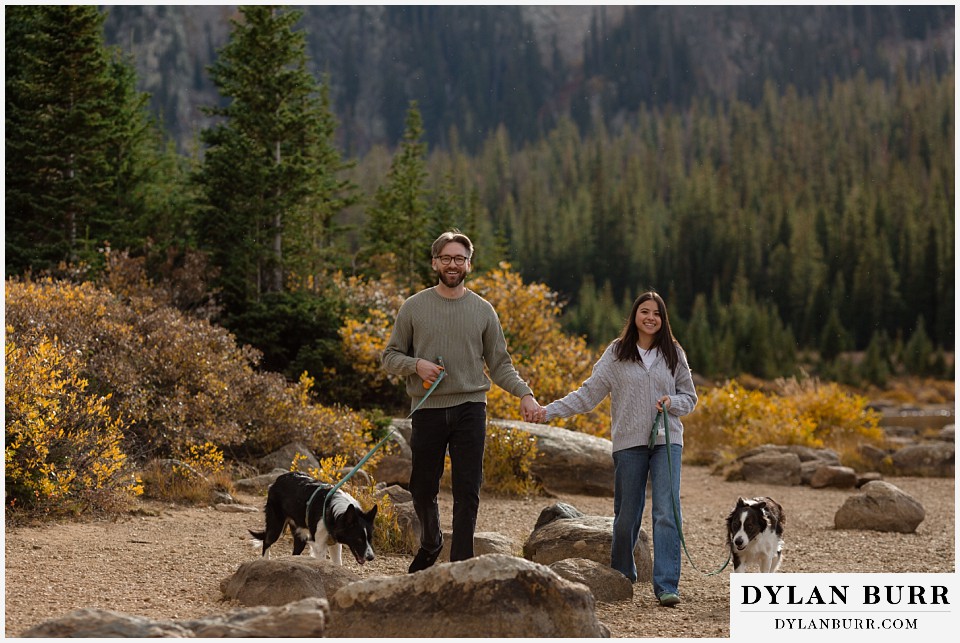 marriage proposal at brainard lake recreation area couple walking with their dogs