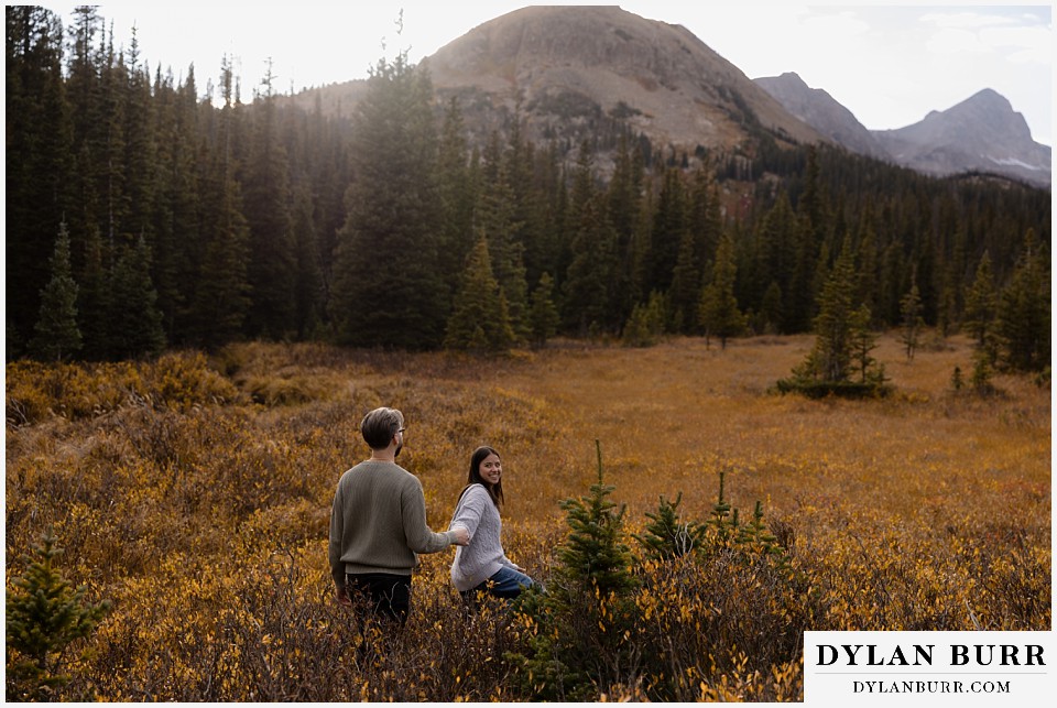 marriage proposal at brainard lake recreation area walking in large mountain valley in the fall