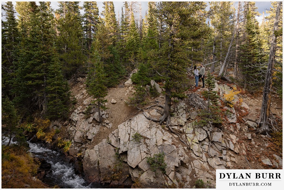 marriage proposal at brainard lake recreation area couple near small river and cool cliffs
