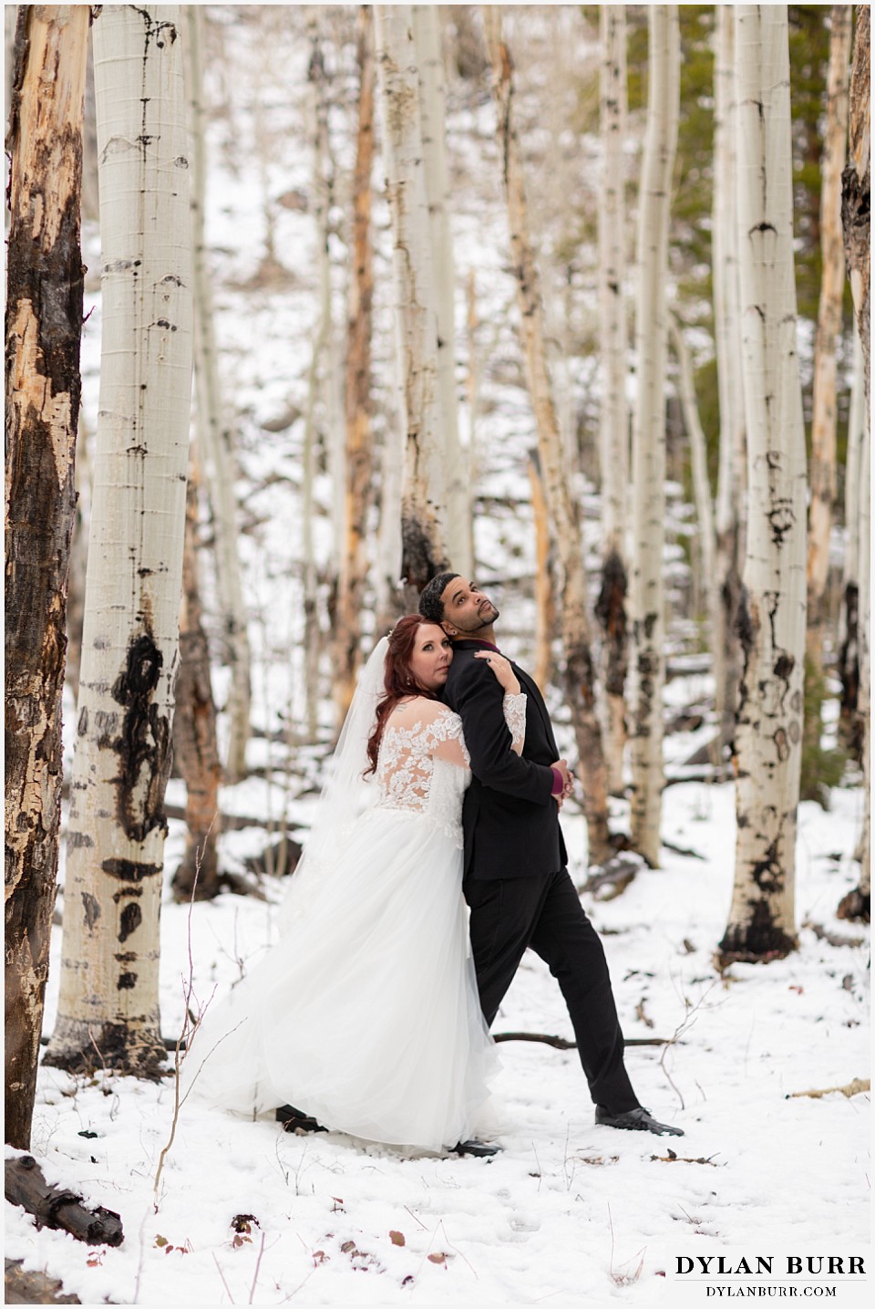 bride hugging her husband in aspen trees during their winter wedding
