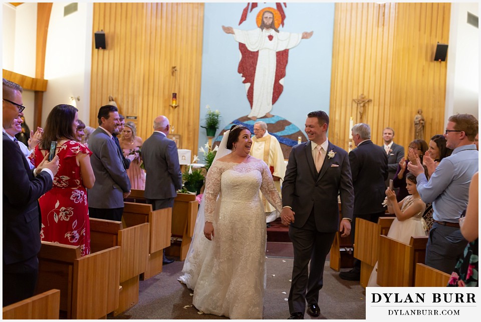 mother cabrini shrine wedding golden colorado bride and groom leaving ceremony together