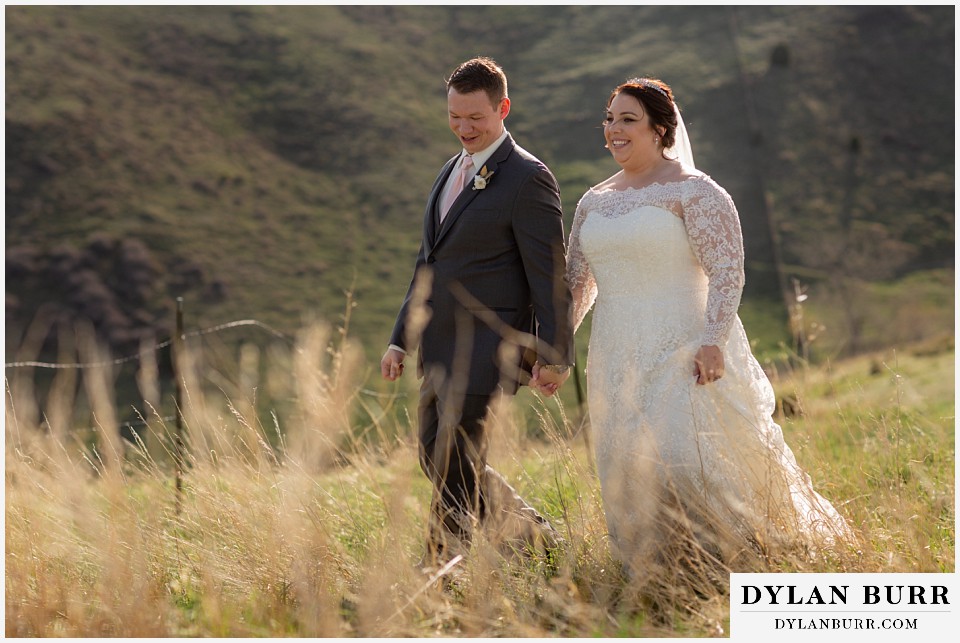mother cabrini shrine wedding golden colorado bride and groom walking together in mountain meadow
