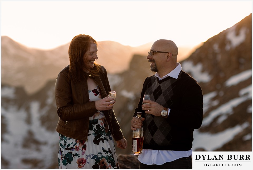 engagement photos of couple in mountains at sunset