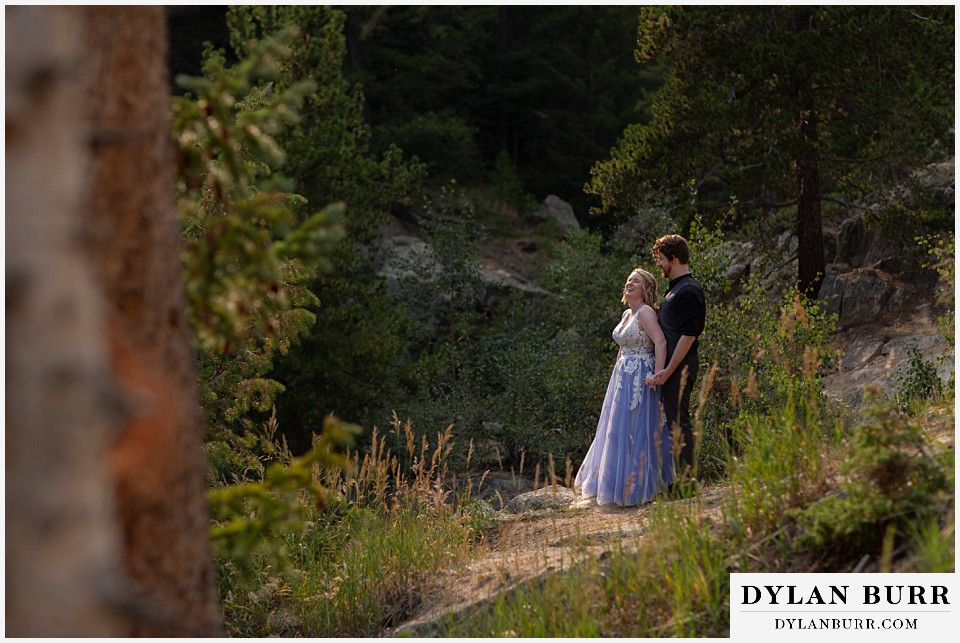 mountain adventure elopement wedding colorado bride and groom laughing together along creek