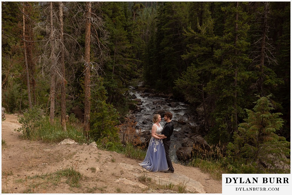 mountain adventure elopement wedding colorado bride and groom together with river running in background