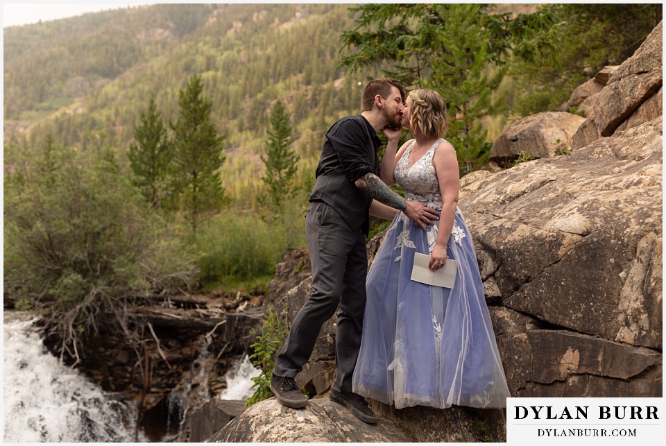 mountain adventure elopement wedding colorado bride and groom first kiss