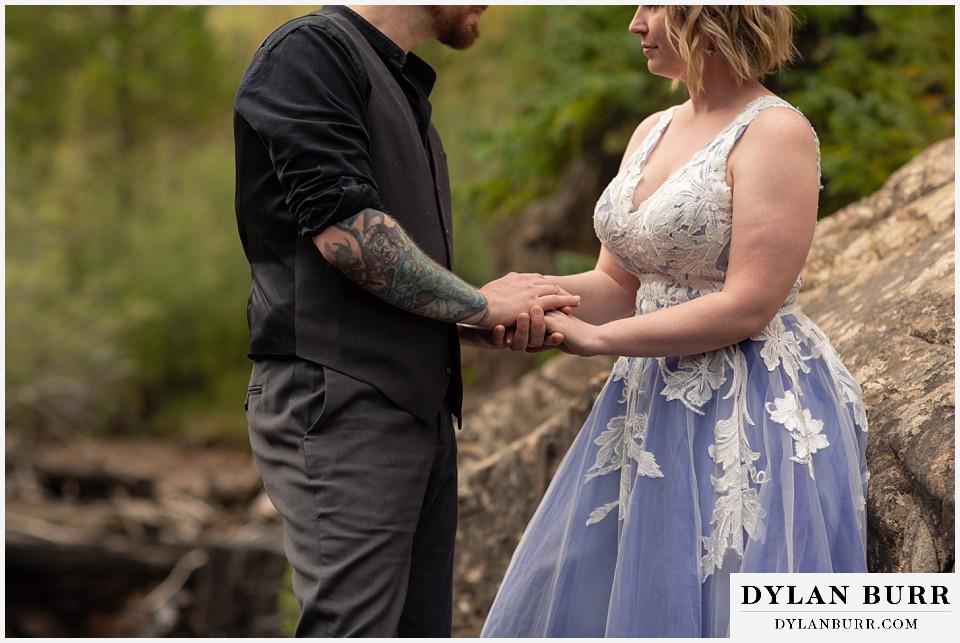 mountain adventure elopement wedding colorado groom holding his brides hands closely