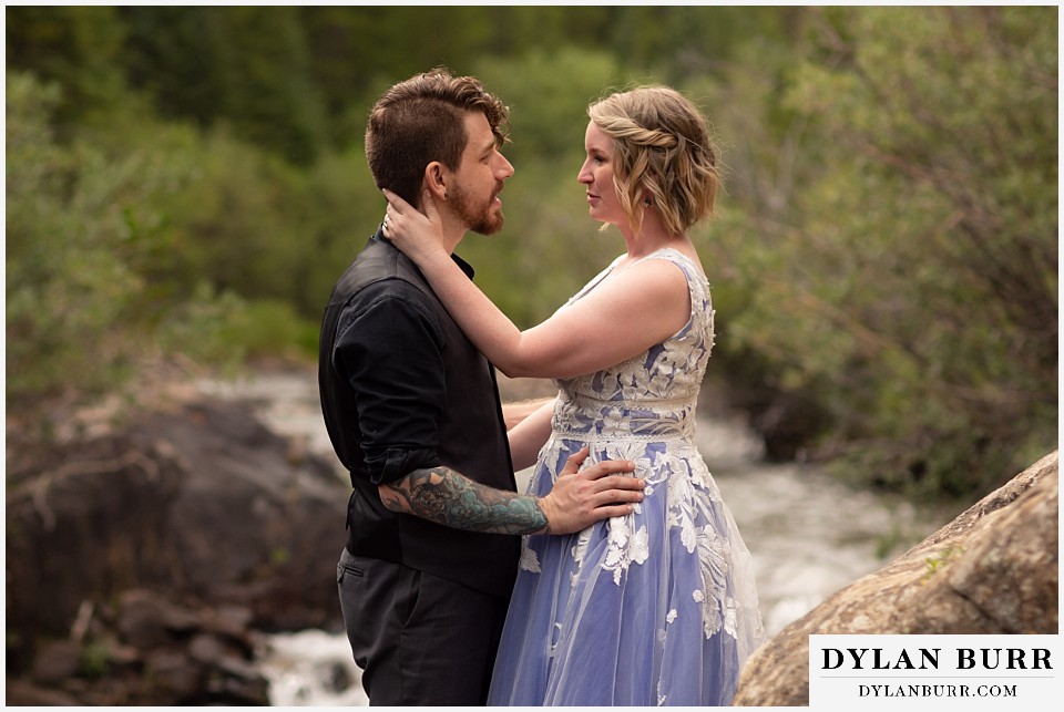 mountain adventure elopement wedding colorado bride touching her husbands back of his neck