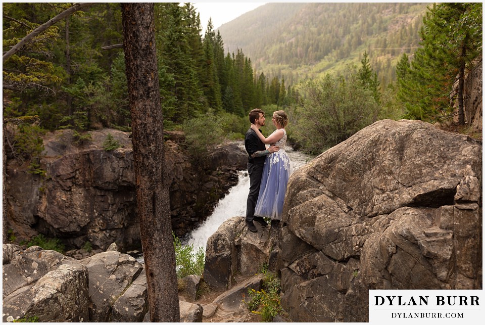 mountain adventure elopement wedding colorado bride and groom together in mountains near waterfall