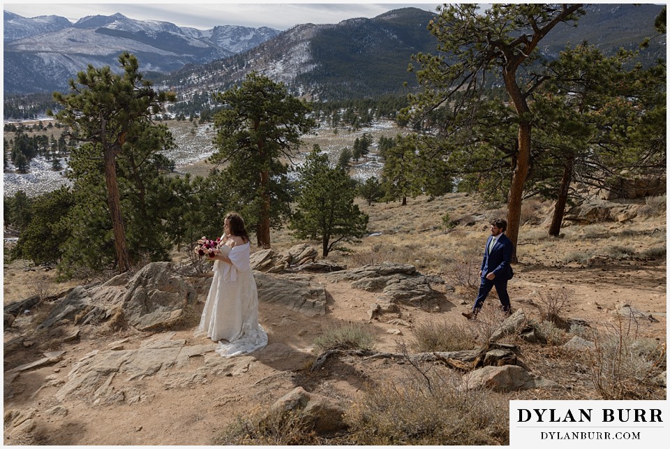 November elopement wedding in rocky mountain national park groom walking to bride during first look