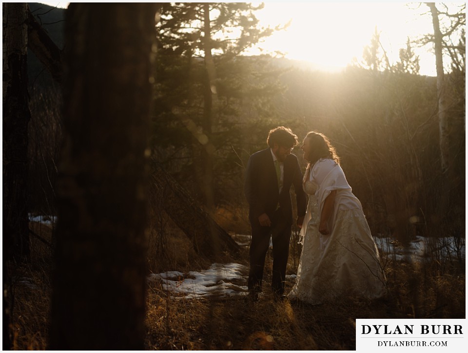 November elopement wedding in rocky mountain national park couple laughing together at sunset