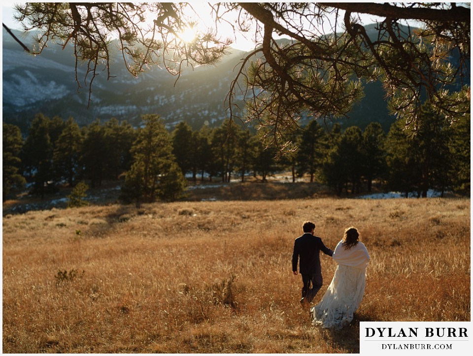 November elopement wedding in rocky mountain national park couple walking out in golden meadow