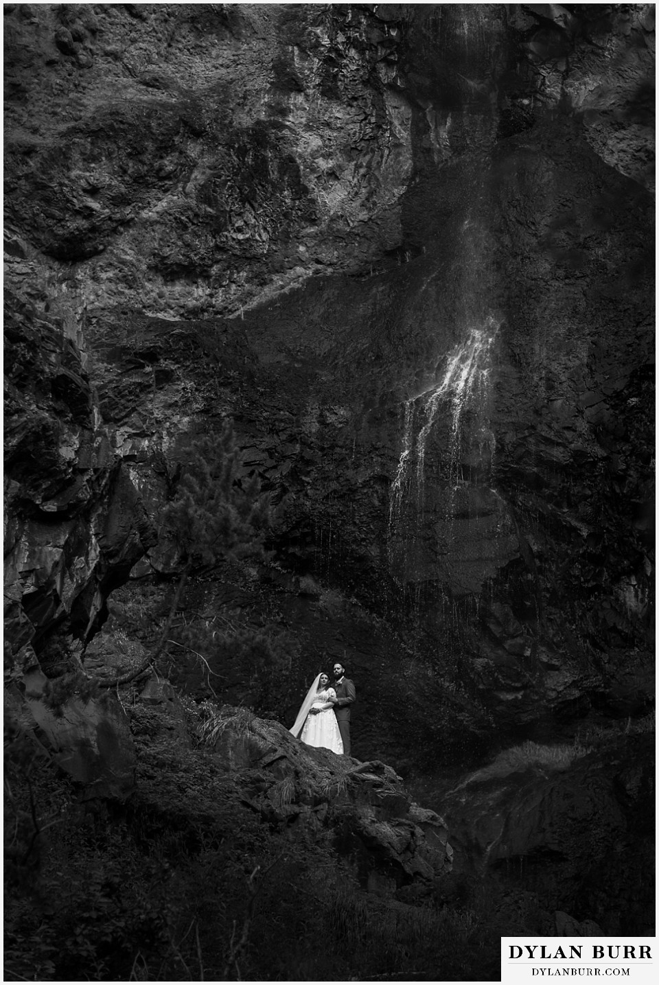 pagosa springs elopement bride and groom near waterfall black and white