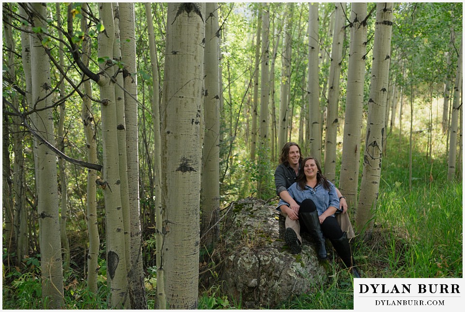 fall mountain engagement photo session hanging in green aspens