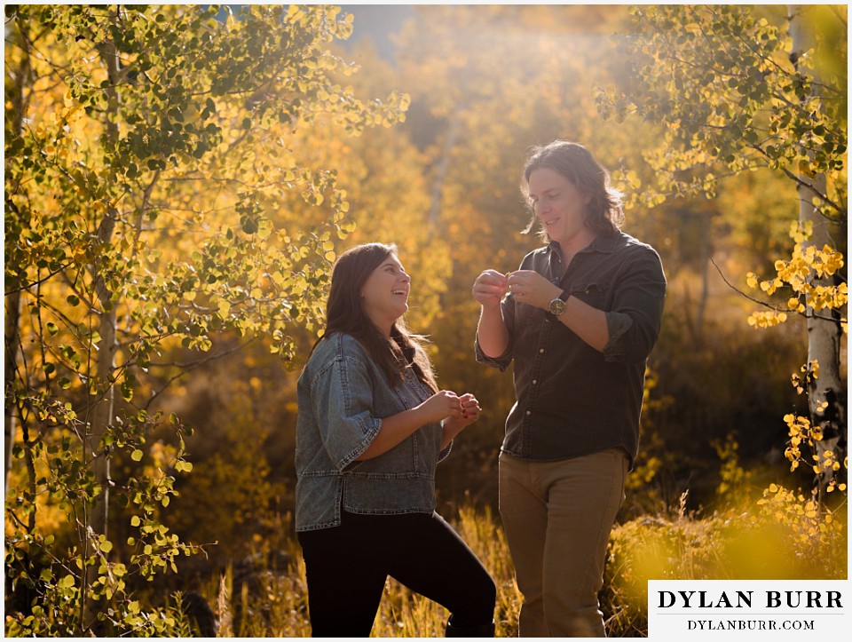 fall mountain engagement photo session laughing together in golden leaves