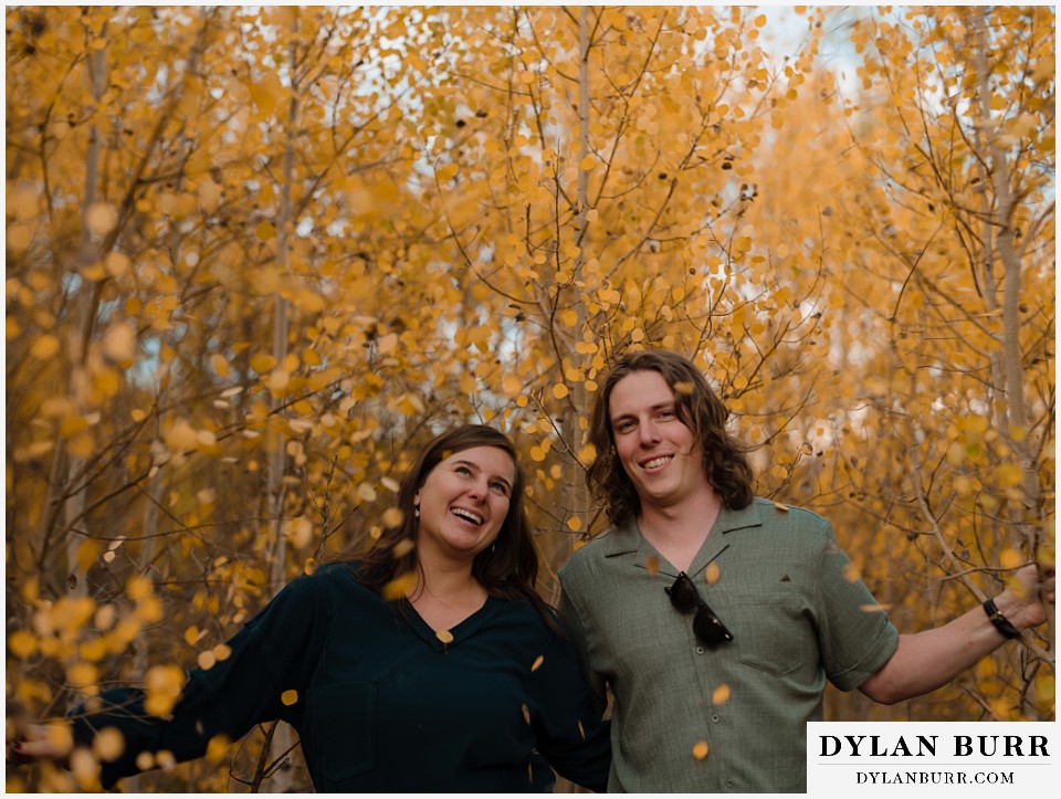 fall mountain engagement photo session a fun moment playing in the gold aspens