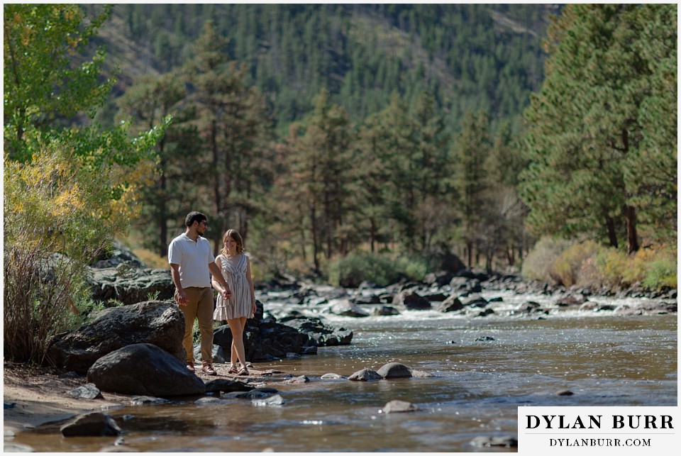 poudre canyon marriage proposal walking together down the creekside