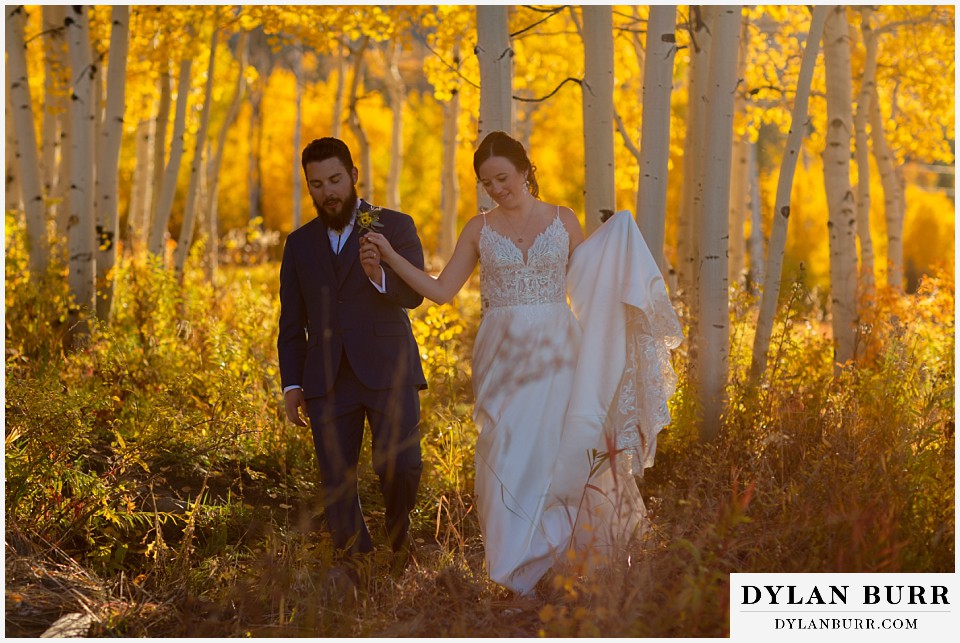 powderhorn mountain resort wedding bride and groom walking through forest together