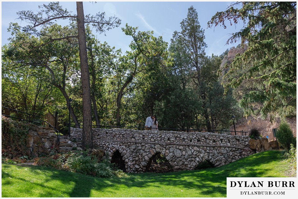 proposal at glen eyrie castle colorado springs walking across bridge