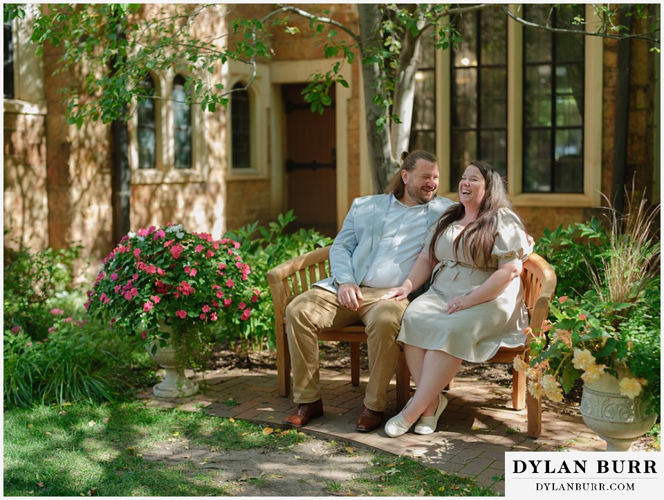 proposal at glen eyrie castle colorado springs sitting together on a bench outside