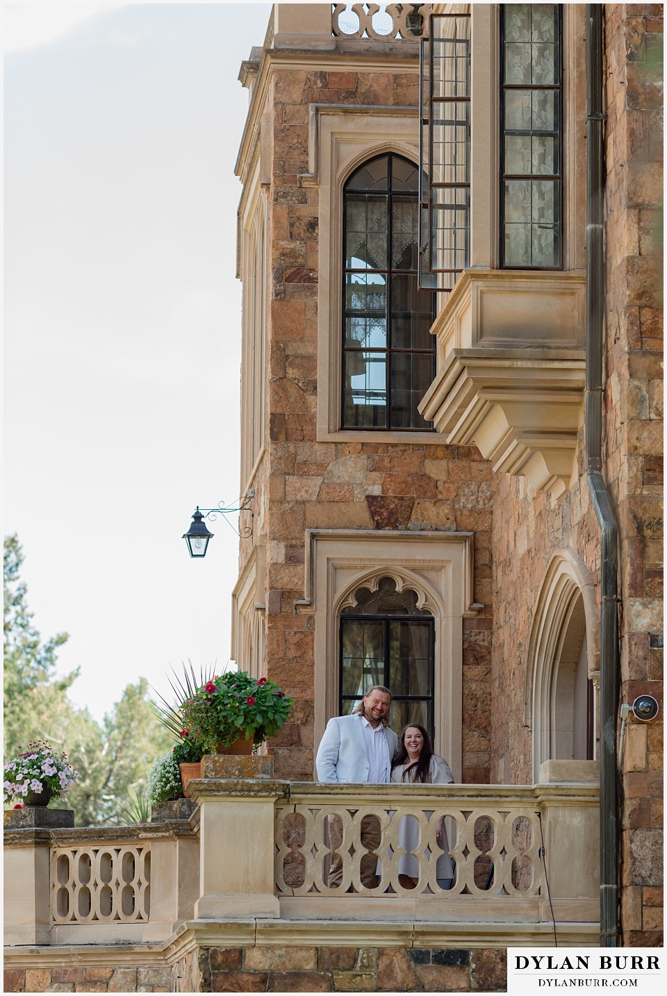 proposal at glen eyrie castle colorado springs newly engaged couple castle balcony