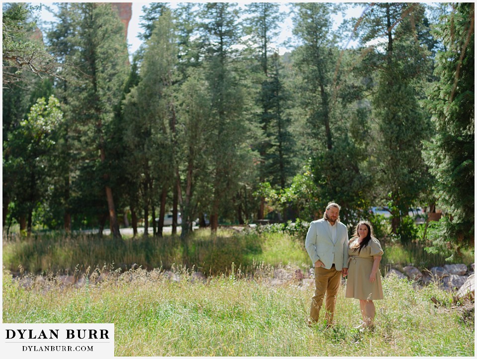 proposal at glen eyrie castle colorado springs standing together in meadow