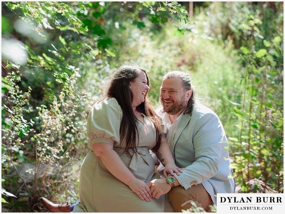 proposal at glen eyrie castle colorado springs cuddling together on a rock