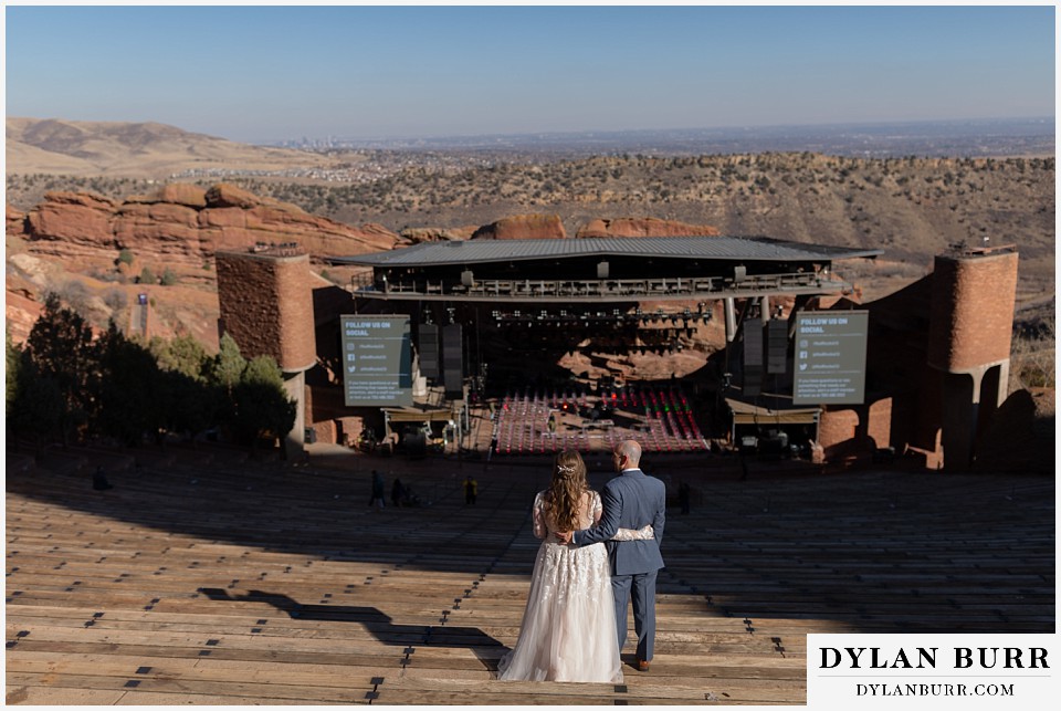 red rocks trading post wedding couple looking at stage