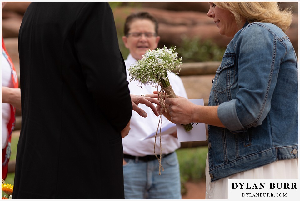 red rocks wedding morrison colorado exchanging wedding rings