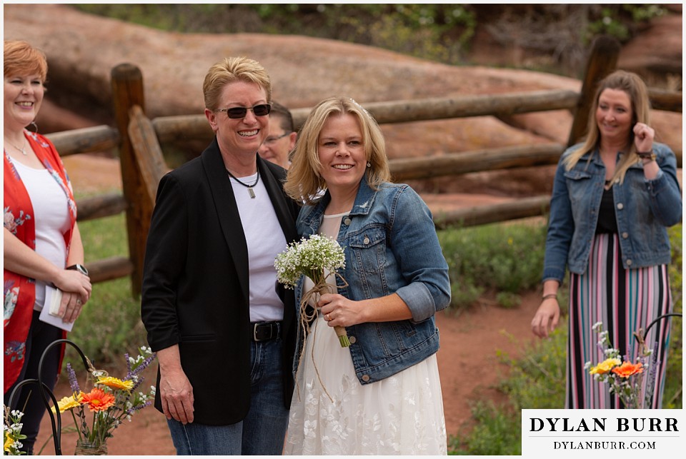 red rocks wedding morrison colorado brides walking together