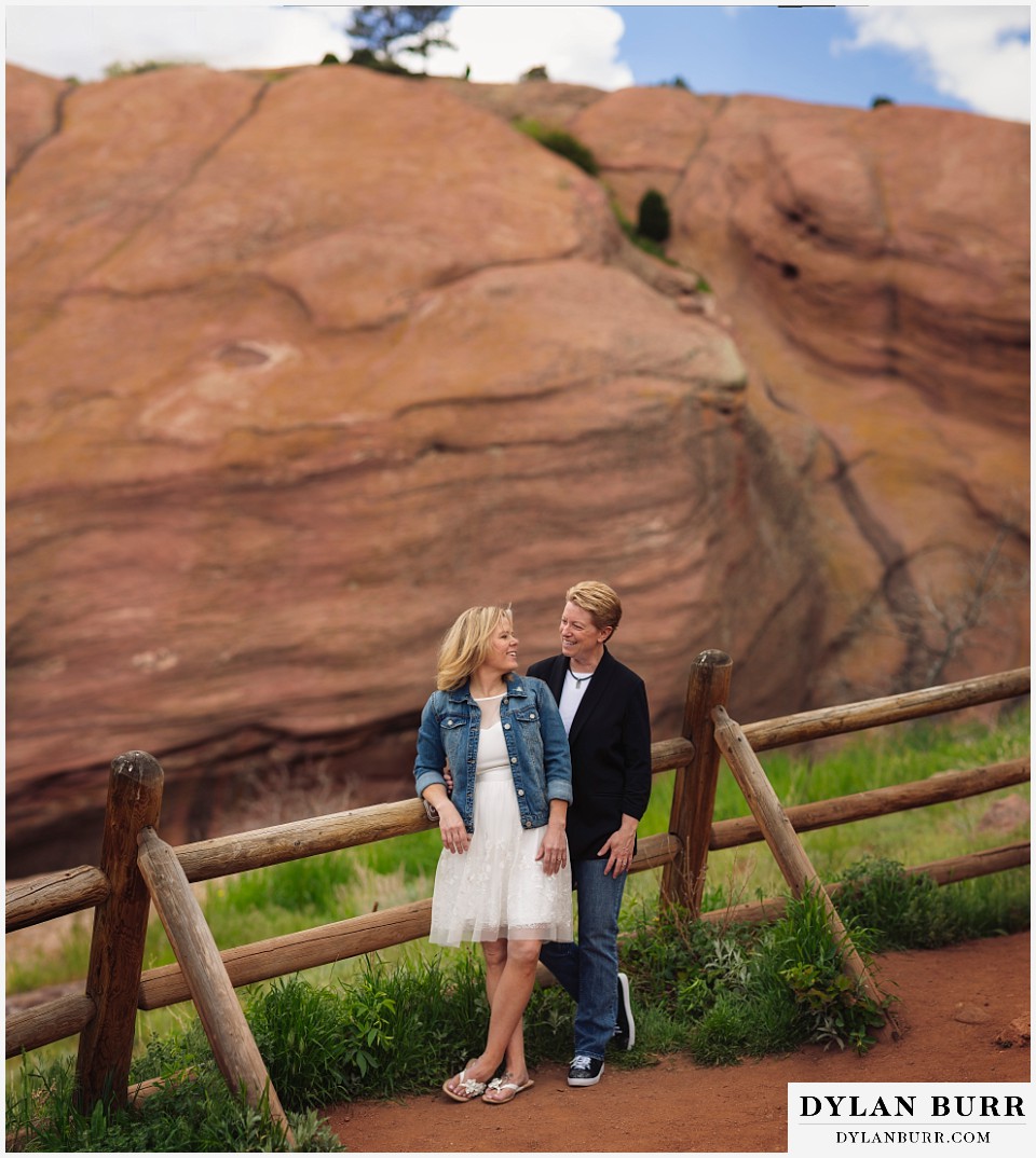 red rocks wedding morrison colorado gay couple along rail fence