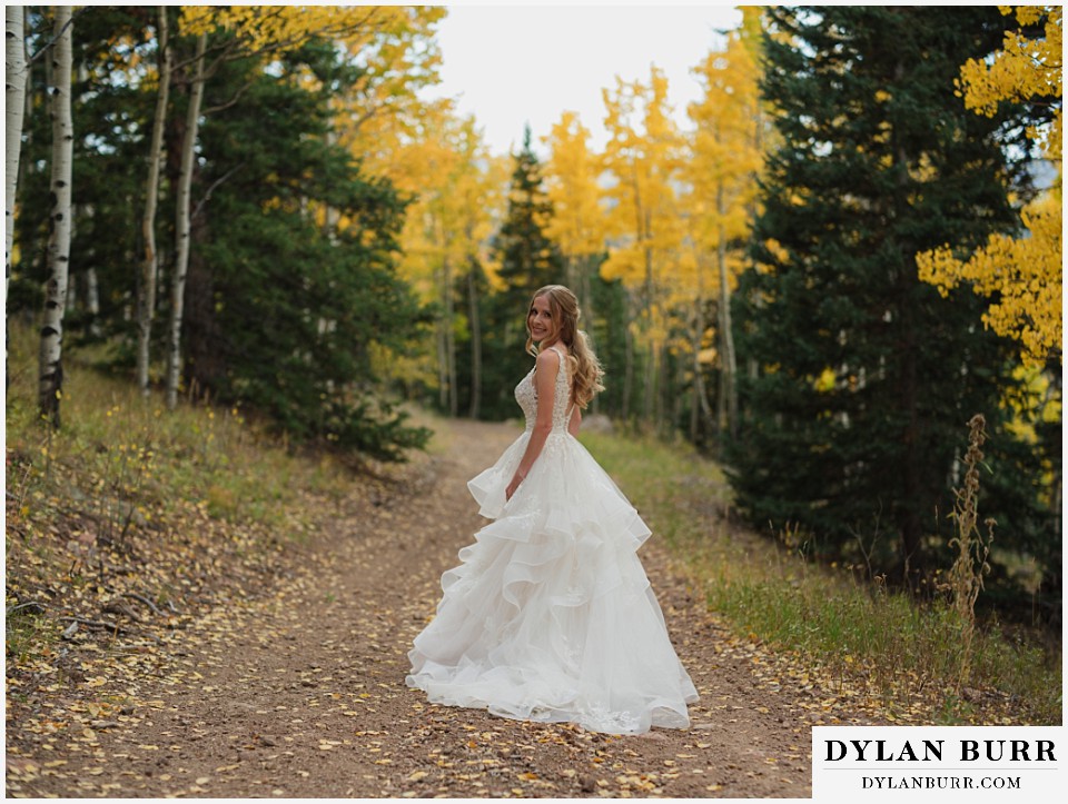 rhize weddings colorado fall yellow aspens around bride waiting on a road