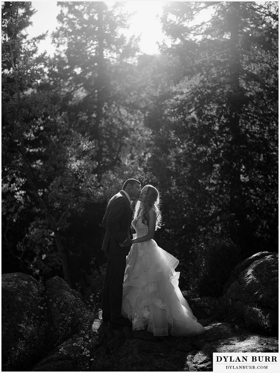 rhize weddings colorado black and white of bride and groom on rock edge light by the sun