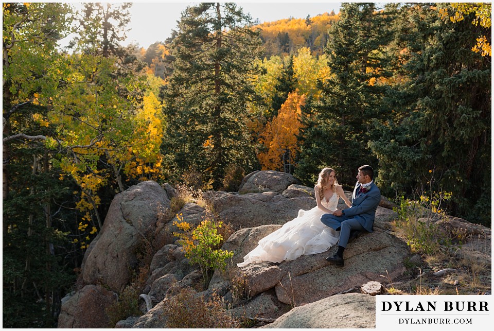 rhize weddings colorado couple together on giant rock in the fall