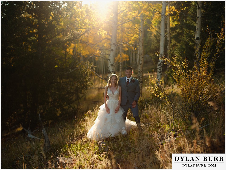 rhize weddings colorado bride and groom together in fall foliage aspen trees