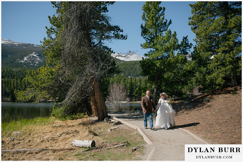 2nd chance at love rocky mountain elopement walking together near mountain lake